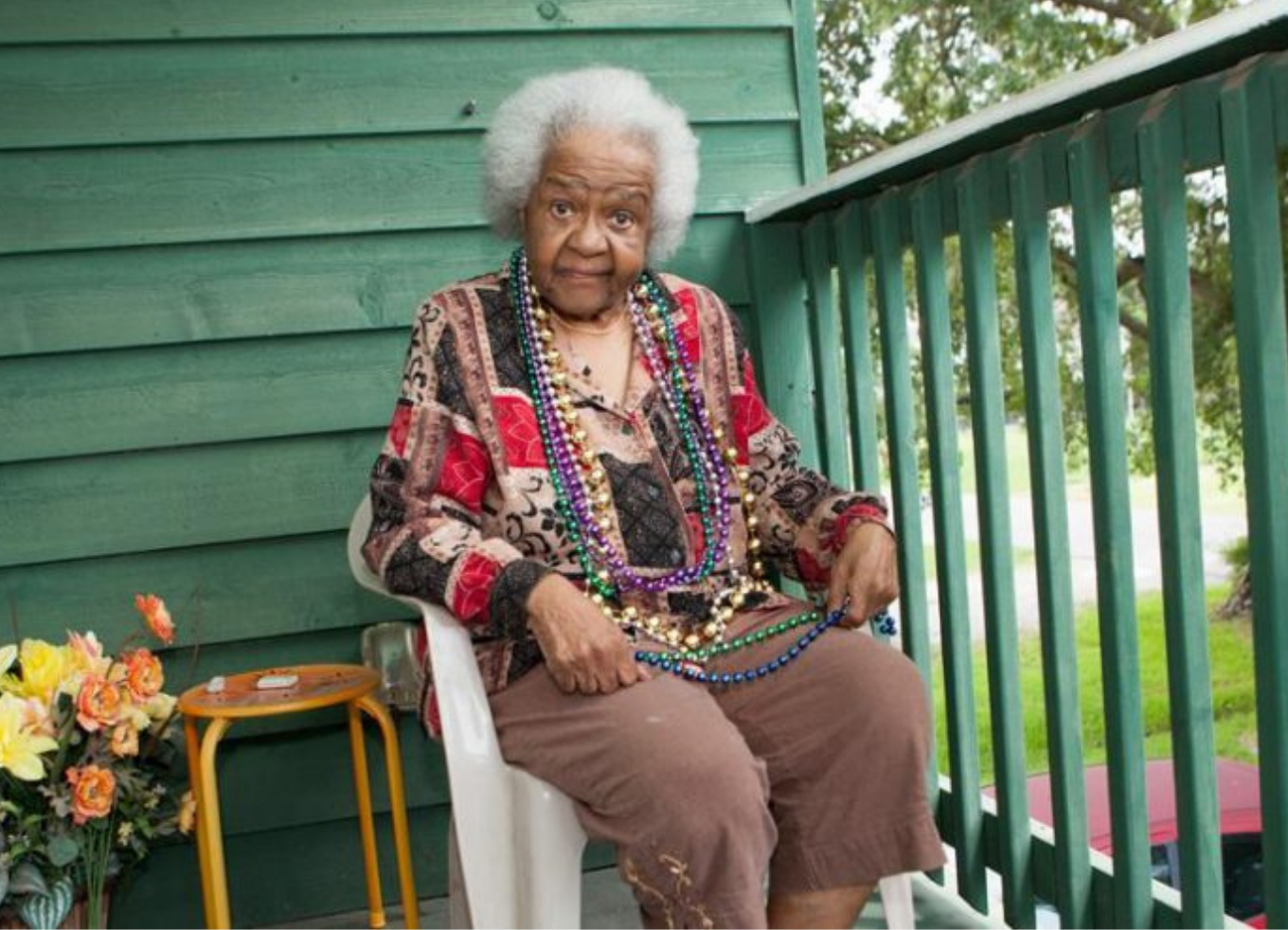 Mae Beth Marshall sitting on her balcony thanks to CDFI senior assistance