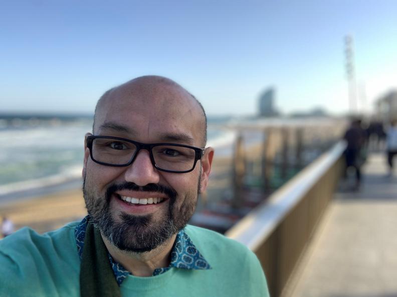 Alex Castro, founder and owner of Life Recovery Centers, takes a selfie at a pier.