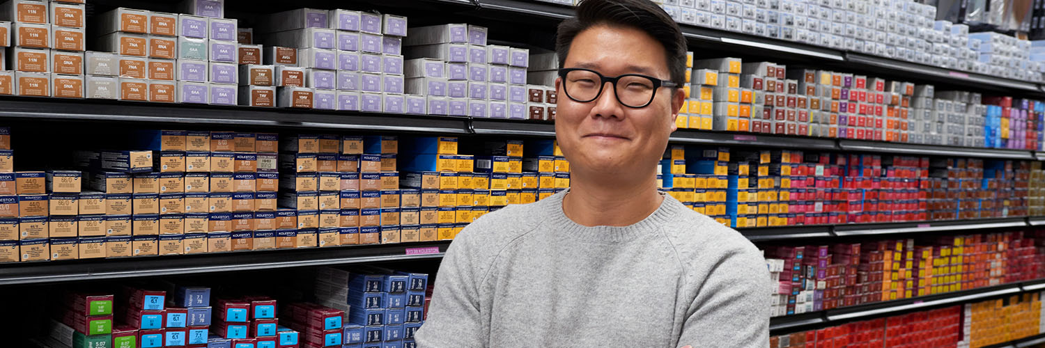 Optima Beauty's owner Andy Hong smiling in the beauty store. He used financing from OFN member Accompany Capital to strengthen his business.