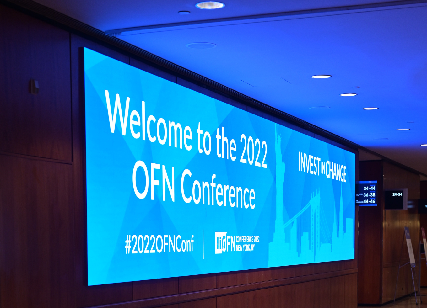 A large screen with a welcome sign for the 2022 OFN Conference