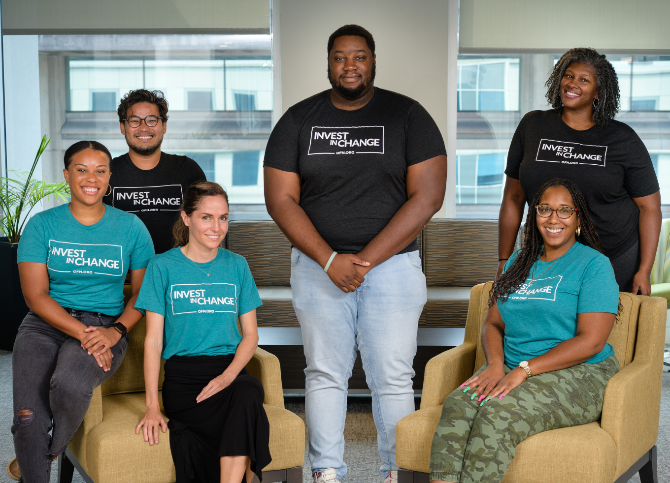 Six OFN team members in "Invest in change" t-shirts