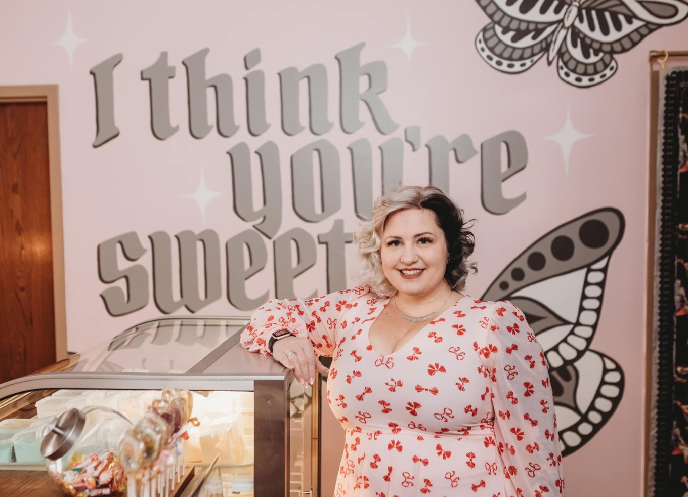 Rachel Slinden Blydenburgh, owner of Sweet Salon and Barber Shoppe, stands smiling in her store.