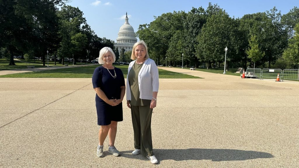 Mary Ellen Judah, executive director of Neighborhood Concepts, and Cindi Rourk, CEO of CLIMB Fund in front of Capitol Hill