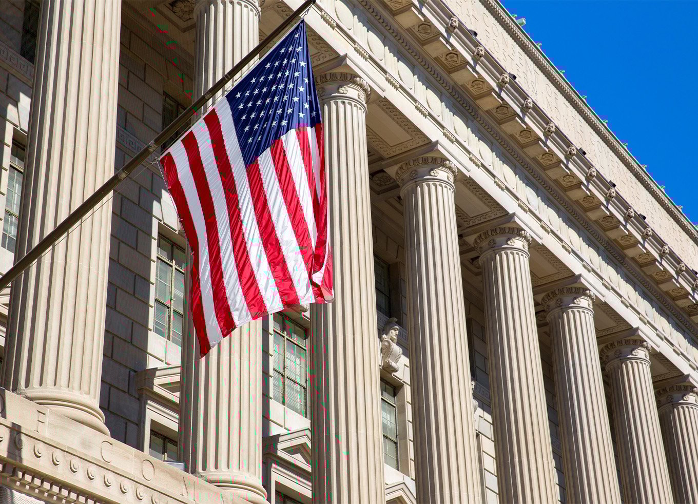 American flag in front of marble columns