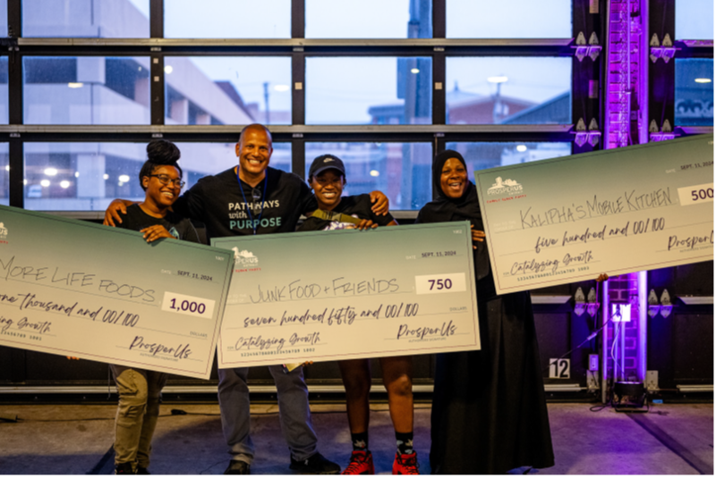 Paul Jones handing out Big Checks at the ProsperUs Family Block Party (2024)