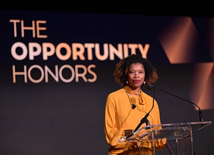 Woman at podium during the opportunity honors