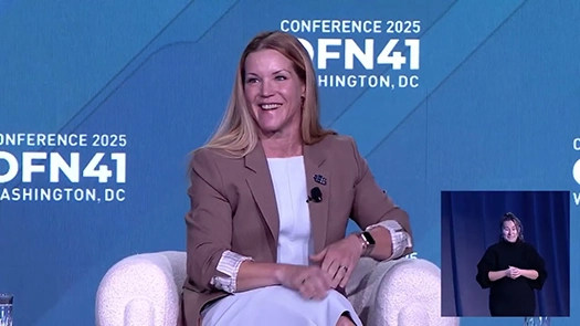 Woman sitting on couch talking during the policy future plenary