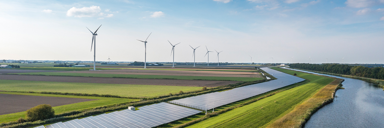 Wind turbines and solar panels in a field