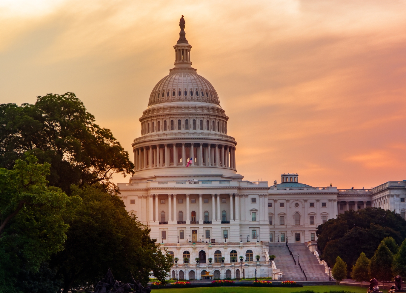 U.S. Capitol building with the sunset behind it.